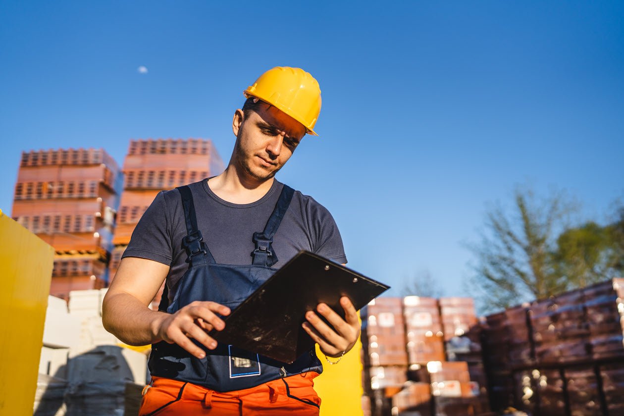 Workman on Site, Pallets, Clipboard